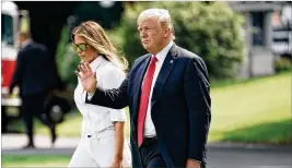  ?? ALEX WONG / GETTY IMAGES ?? U.S. President Donald Trump, seen here recently with fifirst lady Melania Trump, urged Democrats to support border security funding.