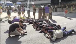  ?? JEFF SINER / THE CHARLOTTE OBSERVER VIA AP ?? Protesters lie in the middle of Fourth Street, Charlotte, N.C., on Friday after a mistrial was declared in police officer Randall Kerrick’s trial for voluntary manslaught­er in the shooting of ex-Florida A&M football player Jonathan Ferrell.