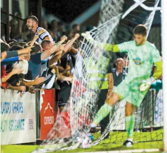  ?? ?? Midfielder Ryan Upward (left) dives into the York Road faithful. Photo Darren Woolley