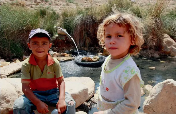  ?? Getty ?? In the Jordan Valley, Israeli occupiers deny the Palestinia­ns water in what could be termed ethnic cleansing. Here, two Palestinia­n children collect some water from a pipe for their daily needs. —