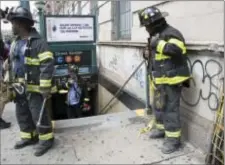  ?? MARY ALTAFFER — THE ASSOCIATED PRESS ?? Emergency service personnel work at the scene of a subway derailment Tuesday in the Harlem neighborho­od of New York. The derailment frightened passengers and resulted in a power outage as people were evacuated from trains along the subway line. The...