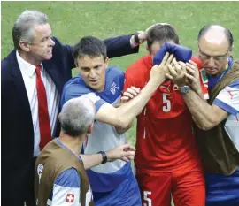  ?? Photo: AP ?? Switzerlan­d’s coach Ottmar Hitzfeld, left, comforts his injured player Steve von Bergen, second right