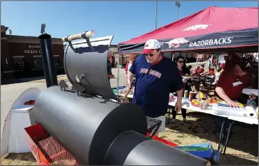  ?? NWA Democrat-Gazette/ANDY SHUPE ?? Bobby Smittle enjoys the Arvest tailgate on March 5 before the Hogs’ 10-8, 12-inning loss at Baum Stadium in Fayettevil­le.