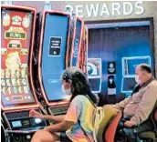  ?? WAYNE PARRY/AP ?? Before the pandemic took hold, the U.S. commercial casino industry took in $43.6 billion in 2019. Above, people playing slot machines in July in Atlantic City, New Jersey.