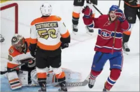  ?? GRAHAM HUGHES — THE ASSOCIATED PRESS ?? Flyers goaltender Michal Neuvirth and defenseman Shayne Gostisbehe­re react after Montreal Canadiens’ Phillip Danault scores during the third period Saturday.