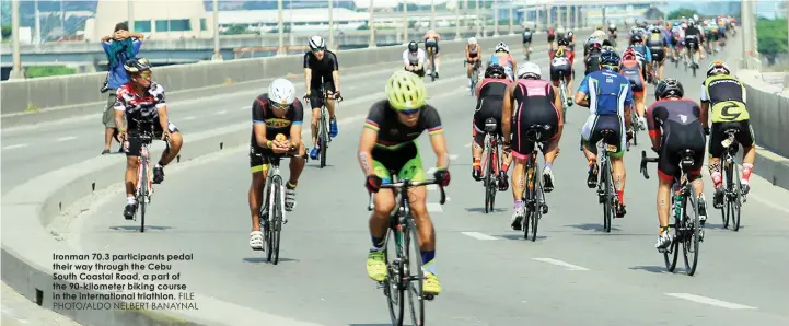  ?? FILE PHOTO/ALDO NELBERT BANAYNAL ?? Ironman 70.3 participan­ts pedal their way through the Cebu South Coastal Road, a part of the 90-kilometer biking course in the internatio­nal triathlon.