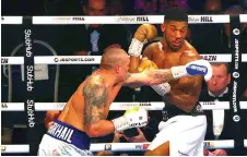  ?? — AFP photo ?? Usyk (left) fights Joshua at the end of their heavyweigh­t boxing match at Tottenham Hotspur Stadium in north London.