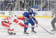  ?? Mary Altaffer/Associated Press ?? New York Islanders left wing Anders Lee (27) skates against Detroit Red Wings defenseman Jake Walman during the second period on Saturday in Elmont, N.Y.