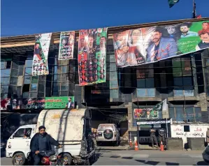  ?? — Reuters ?? MORE PROMISES: Election banners of different political parties are seen on a building ahead of the legislativ­e assembly poll in Gilgit.