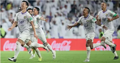  ??  ?? Al Ain players celebrate their dramatic win over Wellington fC in the fifa Club World Cup opening match.