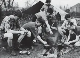  ??  ?? Tradition: Scouts gather by the fire at a London park in 1943