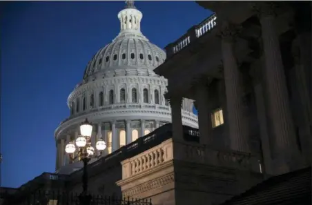  ?? ASSOCIATED PRESS ?? The Capitol is seen at day’s end as the Senate works on a House-passed bill that would pay for President Donald Trump’s border wall and avert a partial government shutdown, at the Capitol in Washington.