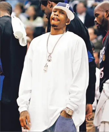  ?? CHARLES DHARAPAK/ AP FILE PHOTO ?? From now on, according to 63-year-old NBA commission­er David Stern, Allen Iverson of the Philadelph­ia 76ers will be contraveni­ng league’s dress code if he shows up like this. Iverson, sitting out a game last season, is breaking several rules.