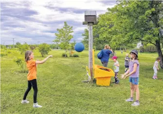  ?? JESSICA SMITH • CAPE BRETON POST ?? Nia Neville, left, and Stella Burns play with a ball from the Busy Bees Playbox, at Southend Public Gardens in Sydney.