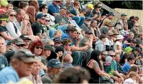  ??  ?? The crowd at the Stratford Speedway on Saturday while two competitor­s get too close for comfort.