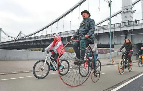  ?? AFP ?? A man rides a penny farthing bicycle during a retro bicycle race in Moscow. Last year, 196,000 people pedalled around the city on the 320,000 bicycles under the bike sharing system Velobike. Authoritie­s spend 150 million roubles annually on the scheme.