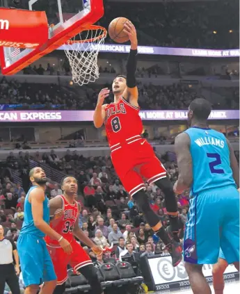  ?? DAVID BANKS/AP ?? Guard Zach LaVine, going up for a dunk in the first half, had a game-high 32 points Wednesday night at the United Center in the Bulls’ first victory of the season.