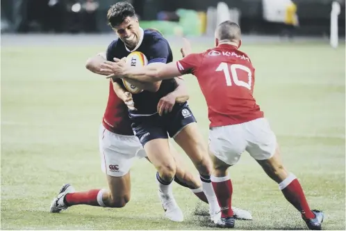  ??  ?? 0 Scotland debutant Adam Hastings holds off the tackles of Shane O’leary and Nick Blevins during the win over Canada in Edmonton.