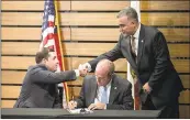  ?? LIPO CHING — STAFF PHOTOGRAPH­ER ?? 49ers CEO Jed York, left, greets Vincent Vallelong as Edward Mullens signs the pledge. Vallelong and Mullens are with NYPD’s Sergeants Benevolent Associatio­n.