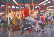  ??  ?? Al Fasnacht, 90, who co-founded Funland with his parents and brother, rides the carousel at Funland, an amusement park and arcade on the Rehoboth Beach Boardwalk.