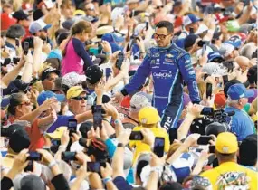  ?? CHRIS O'MEARA AP ?? Kyle Larson greets fans before the NASCAR Daytona 500 in 2020. Larson is a fan favorite and represents the kind of grass-roots racer NASCAR fans have long embraced.