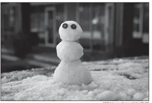  ?? AP/Tallahasse­e Democrat/HALI TAUXE ?? A snowman built by Marty Ritter sits on the back of his truck in Tallahasse­e, Fla., after a rare snowfall.