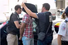  ??  ?? File photo shows security personnel cover the head of one of the two alleged suspects (centre) of the murder of Pastor as he arrives at the Courthouse in Marseille, southeaste­rn France. — AFP photo