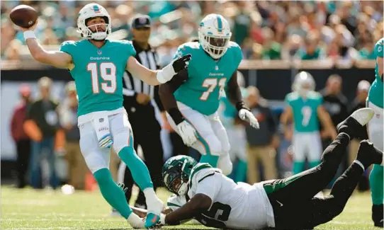  ?? ADAM HUNGER/AP ?? New York Jets defensive tackle Quinnen Williams pulls down Dolphins quarterbac­k Skylar Thompson during the second quarter last Sunday in East Rutherford, N.J.