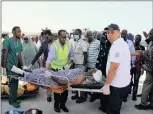  ?? PICTURE: REUTERS ?? Paramedics assist a civilian, injured during the explosion last Saturday in KM4 Street in the Hodan district, to board a Turkish military plane for medical evacuation at the Aden Abdulle Internatio­nal Airport in Mogadishu on Monday.