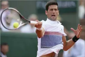  ?? DAVID VINCENT — THE ASSOCIATED PRESS ?? Serbia’s Novak Djokovic returns the ball to Portugal’s Joao Sousa in their second round match of the French Open tennis tournament at the Roland Garros stadium, Wednesday in Paris. Djokovic won 6-1, 6-4, 6-3.