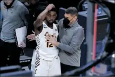  ?? DARRON CUMMINGS ?? LOYOLA CHICAGO HEAD COACH PORTER MOSER (right) consoles guard Marquise Kennedy after a Sweet 16 game against Oregon State in the men’s college basketball tournament at Bankers Life Fieldhouse March 27 in Indianapol­is.