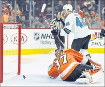  ?? TOM MIHALEK — ASSOCIATED PRESS ?? The Sharks’ Tomas Hertl skates past Flyers goalie Brian Elliott after scoring during the third period in San Jose’s 8-2 victory in Philadelph­ia.