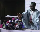  ?? BEN CURTIS — THE ASSOCIATED PRESS ?? Mahmood Yakubu, chairman of the Independen­t National Electoral Commission, receives a document as results for individual Nigerian states are read out at the National Collation Centre in Abuja, Nigeria, on Wednesday.