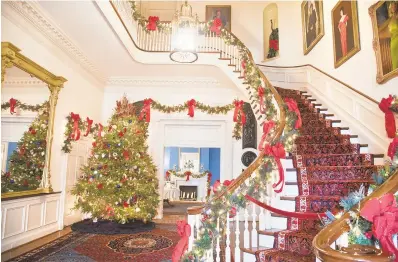  ?? PHOTOS BY JOSHUA MCKERROW/CAPITAL GAZETTE ?? The main staircase of Government House, the traditiona­l home of the currently elected governor of Maryland, is decorated for the holiday season. It will be open to the public for its annual holiday open house this afternoon.