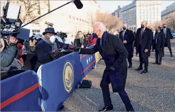  ?? Doug Mills / Getty Images ?? President Joe Biden greets NBC anchor Al Roker as he and and first lady Dr. Jill Biden walk along Pennsylvan­ia Avenue in front of the White House during Inaugural celebratio­ns Wednesday.