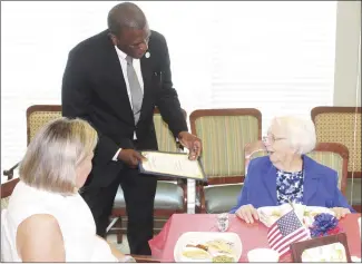  ?? Katie West • Times-Herald ?? Mable Eutha Bankston, right, celebrated her 102nd birthday Thursday at St. Francis County Assisted Living Center. Forrest City, Mayor Cedric Williams presents Bankston a proclamati­on naming the day after her and awards her a seal of the city. Bankstn was born in 1920 in Holdenvill­e, Okla. She married C.R. Bankston and followed him to Germany where he was serving in the U.S. Air Force during World War II. Bankston, an avid bridge player, relocated to Forrest City in 2021 to be closer to family.