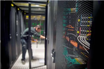  ?? AFP file ?? An employee of Equinix data centre checking servers at Seine-Saint-Denis department in Pantin, a suburb north of Paris. —