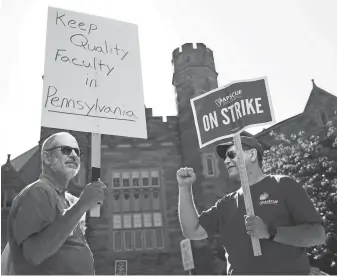  ?? MATT ROURKE, AP ?? Faculty members Chuck Shorten, left, and Brent Thompson picket at West Chester University on Wednesday, when faculty at 14 Pennsylvan­ia state universiti­es went on strike.