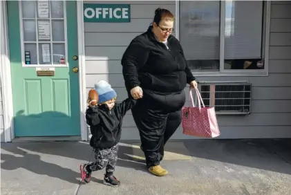  ?? STAFF PHOTO BY DOUG STRICKLAND ?? Rachel Galorath and her son, Jackson Prouse, leave the office of Hamilton Inn on Friday, where Galorath lives and works. Galorath and Jackson have been enrolled in the city’s Baby University program for almost two years.