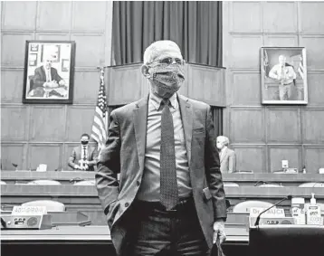  ?? KEVIN DIETSCH/GETTY-AFP ?? Dr. Anthony Fauci leaves a House committee hearing on the Trump administra­tion’s response to the COVID-19 pandemic.