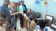  ??  ?? Chairman of Hanover Charities Katrin Casserly makes a point as students test out the computers at the new laboratory at the Church Hill Primary School.