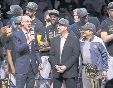  ?? JOSE CARLOS FAJARDO — STAFF PHOTOGRAPH­ER ?? NBA commission­er Adam Silver, left, speaks to Warriors co-owners Joe Lacob, center, and Peter Guber, right, before presenting them with the Larry O’Brien trophy after Golden State won Game 4 of the NBA Finals on Friday in Cleveland.