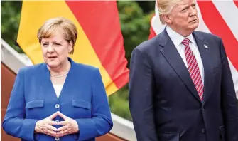  ??  ?? Worlds apart: Angela Merkel and Donald Trump at the G7 in Sicily yesterday