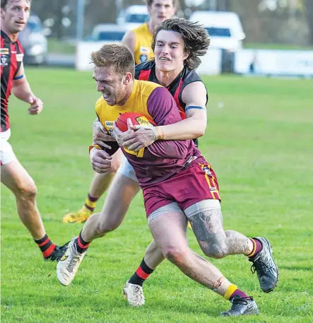  ?? ?? Drouin’s Ryan Quirk is tackled by Maffra’s Noah Christy.