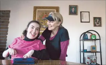  ?? Gina Ferazzi Los Angeles Times ?? ROSITA WHITTAKER, right, is paid $2,990 a month by the state to take care of her disabled daughter Veronica, 21. Gov. Jerry Brown’s proposal would slash that to $1,840, meaning she couldn’t afford her mortgage.