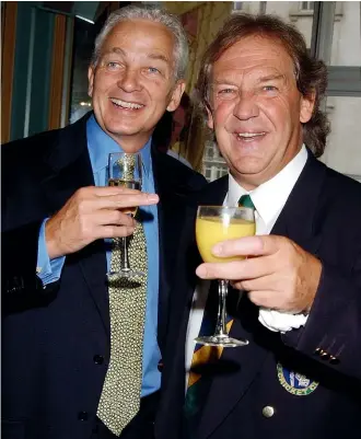 ?? GETTY IMAGES ?? David English, right, with former England captain David Gower at the launch of English’s memoir, Mad Dogs and the Englishman, in 2003.