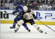  ?? AP FILE ?? Toronto Maple Leafs’ TJ Brodie takes a holding penalty off the Bruins’ Chris Wagner on April 29.