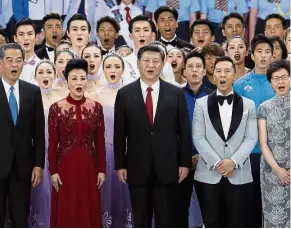  ?? — AP ?? All together: Xi (centre) and his wife Peng Liyuan singing alongside former Hong Kong chief executive Leung Chun-ying (left), Lam (right) and Hong Kong artistes during the anniversar­y celebratio­n grand variety show.