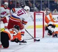  ?? MATT SLOCUM - THE ASSOCIATED PRESS ?? New Jersey Devils forward Dawson Mercer scores a goal against Tony DeAngelo and Carter Hart during the third period Saturday.