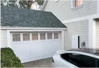  ?? — Reuters ?? Tesla showcased its electric car, home battery and solar roof tiles as part of its vision of a fossil fuel-free lifestyle.